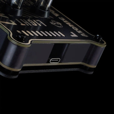 Close-up of a black and gold guitar neck with brand name on a black background